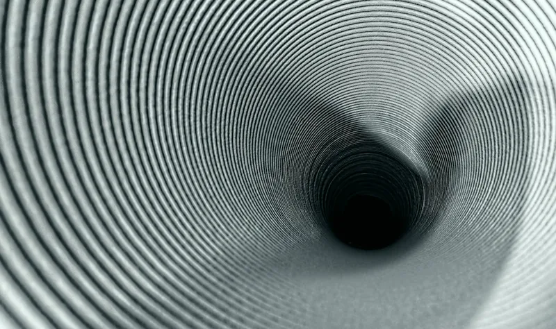 Interior of a dryer vent duct, showing the full run behind the wall that a DIY cleaning can't reach